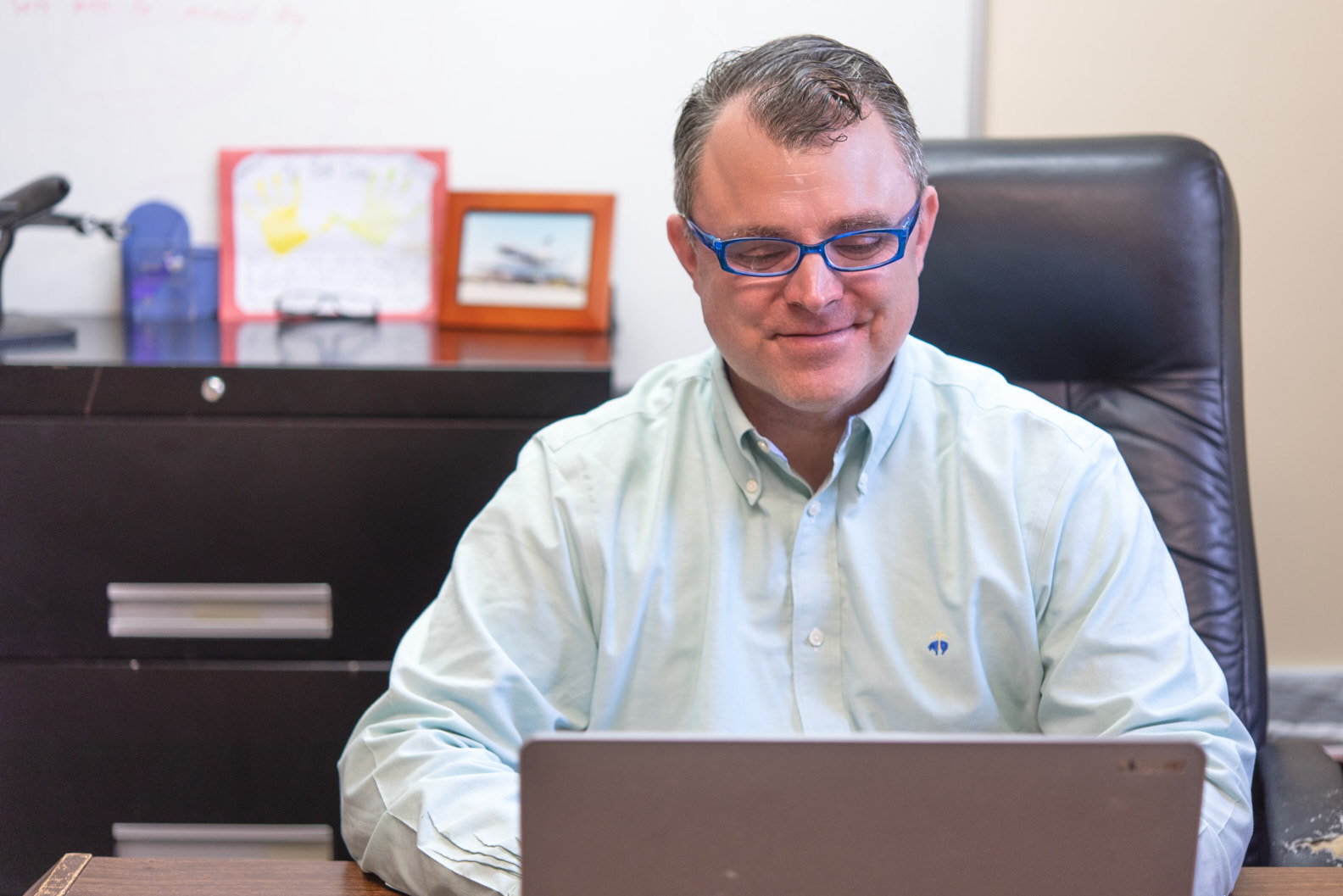 John at his desk, working.